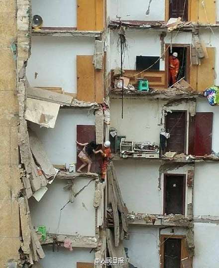 Firefighters rescuing trapped residents in the collapsed building