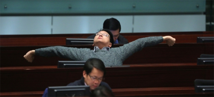 A pro-Beijing camp lawmaker being relaxed at the meeting.