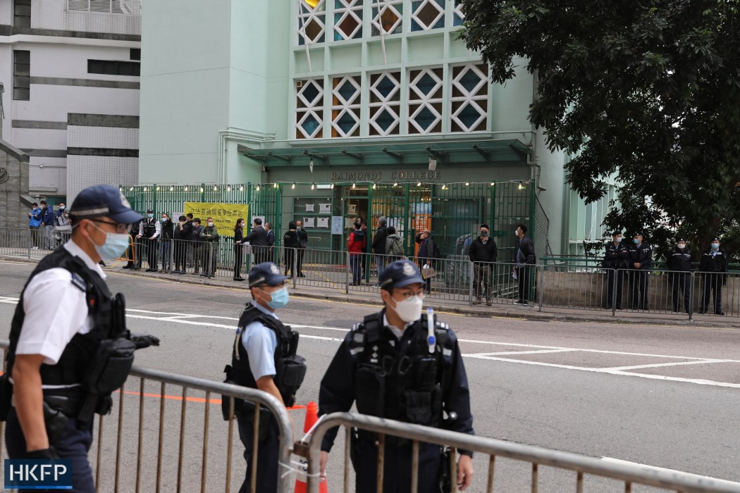2021 legco election: Police officers patrolled along Robinson Road in the Mid-levels as Chief Executive Carrie Lam casted her ballot at the Raimondi College poling station.