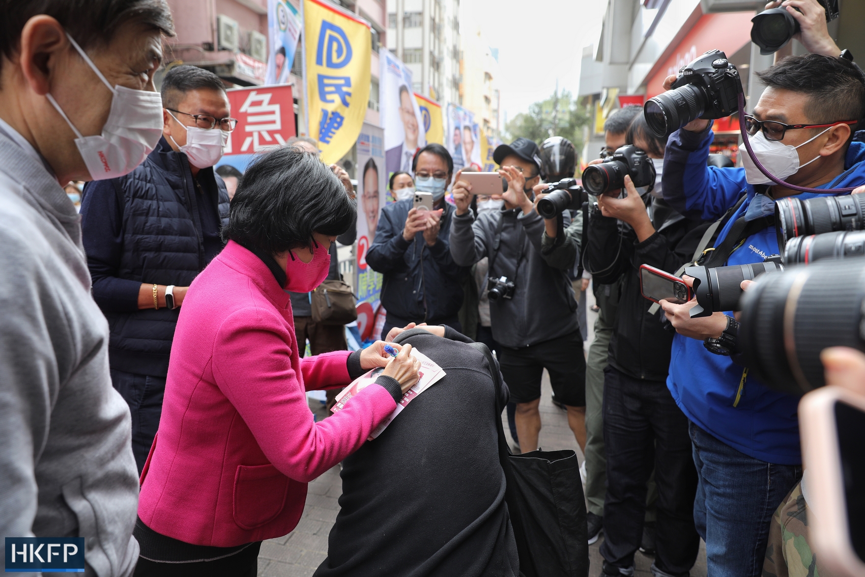 2021 LegCo Election: A supporter asked New People's Party chief Regina Ip to sign an autograph on his back.