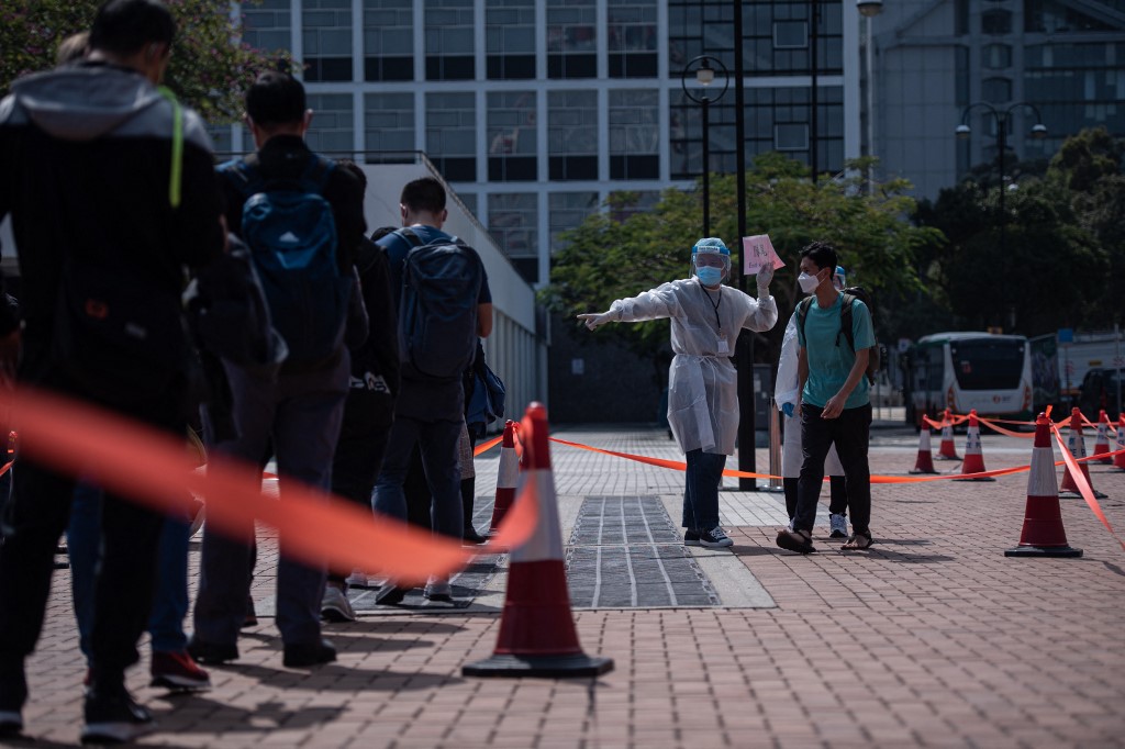 People stand in a queue for the Covid-19 coronavirus testing in Hong Kong on February 12, 2022, as authorities scrambled to ramp up testing capacity following a record high of new infections. 