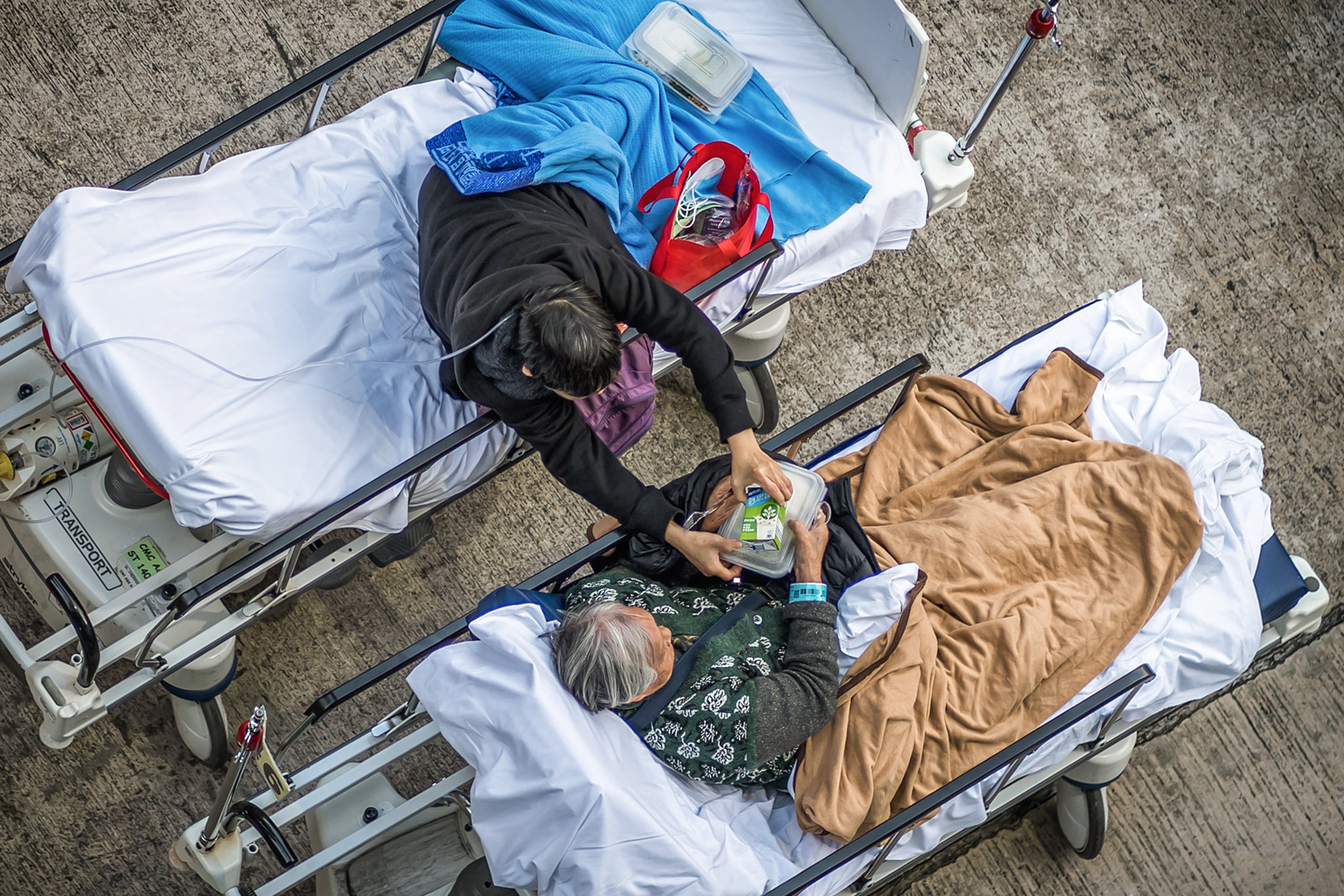 Two elderly patients were seen outside the Caritas Medical Centre in Shum Shui Po on February 16, 2022.