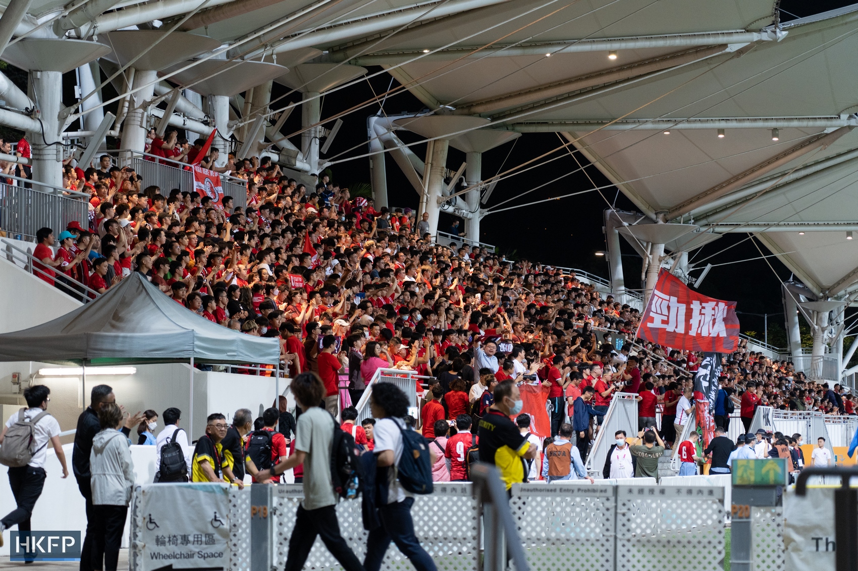 Hong Kong football team supporters cheering at an international friendly match against Singapore on March 23, 2023. 