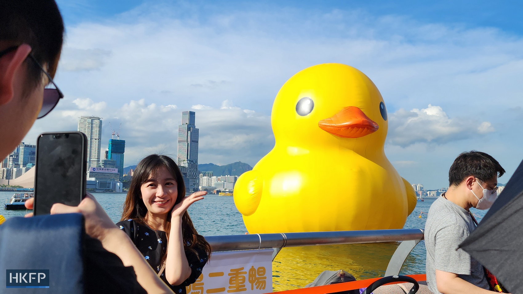 People take photos of a giant rubber duck by Dutch artist Florentijn Hofman in Hong Kong's Victoria Harbour, on June 10, 2023. Photo: Tom Grundy/HKFP.