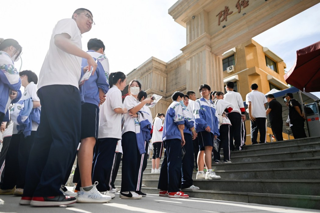 Students line up to enter a school on the first day of China's national college entrance examination, known as the gaokao, in Beijing on June 7, 2023. Photo: Wang Zhao/AFP.