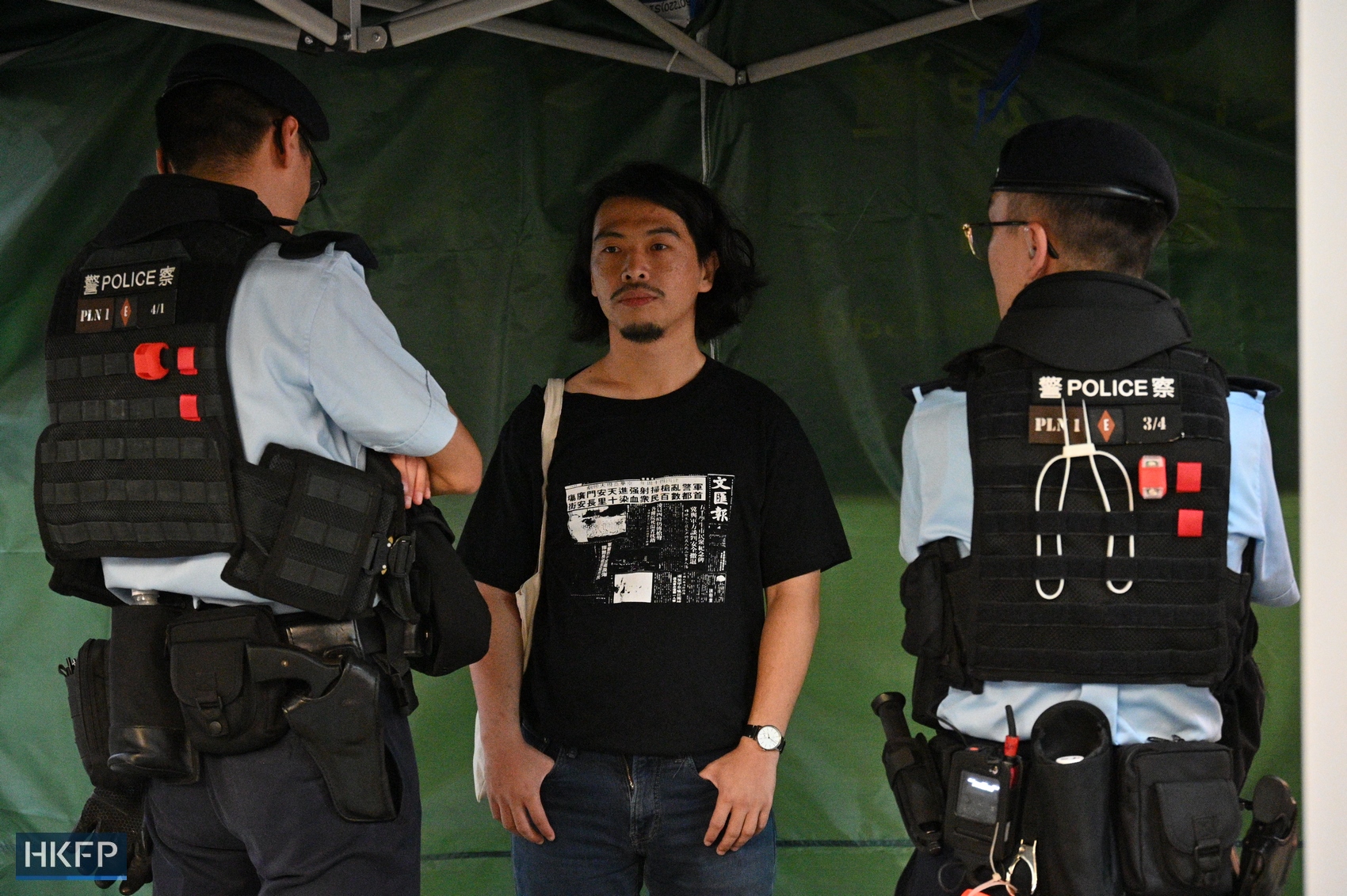 Leo Tang, former vice-chairperson of the HKCTU, is stopped and searched in Causeway Bay, Hong Kong, on June 4, 2023. Photo: Peter Lee/HKFP. 
