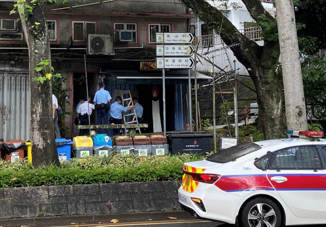 Police officers outside the Sai Kung Store.