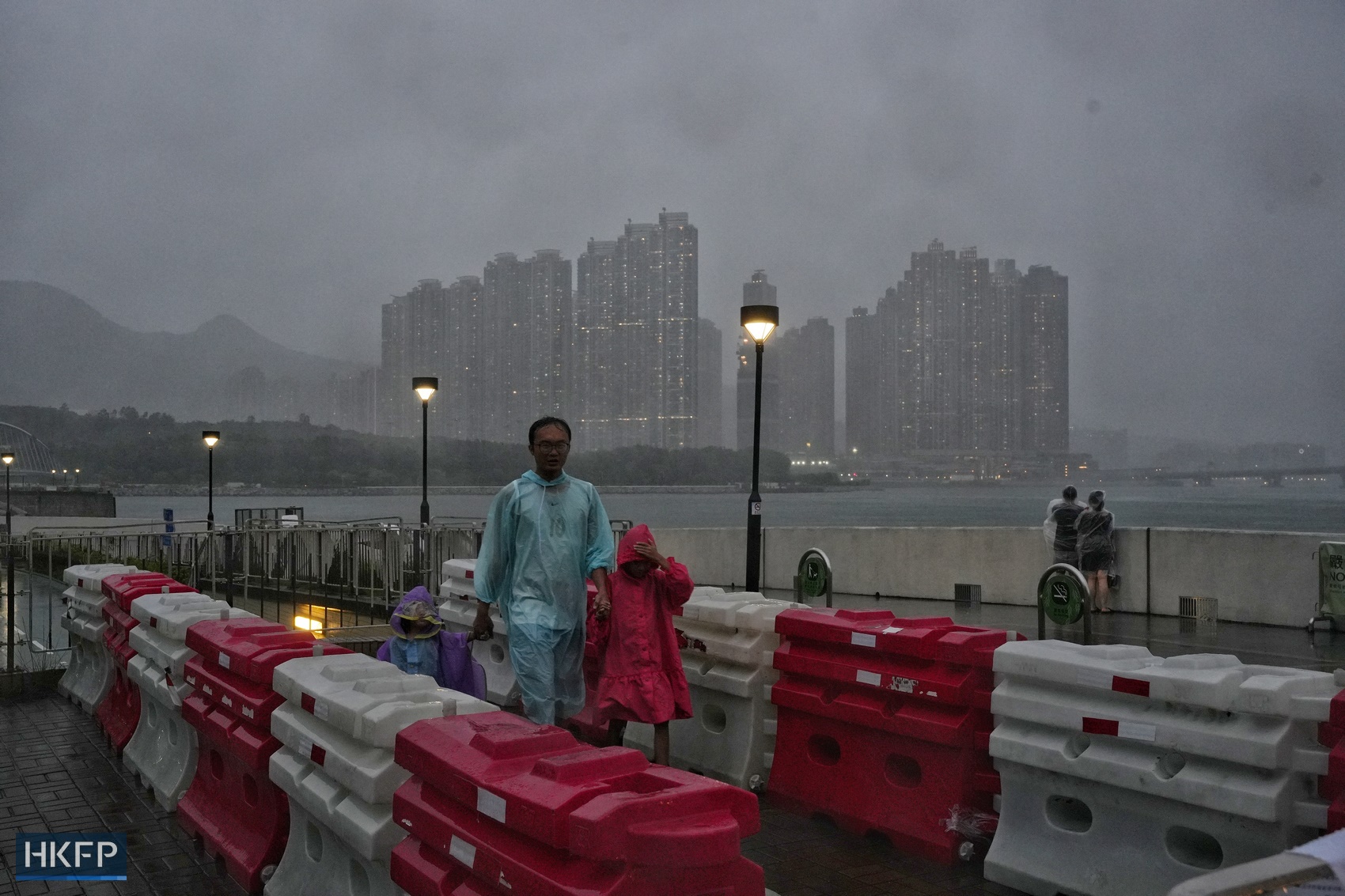 People in raincoats in Tseung Kwan O as Super Typhoon Saola approaches Hong Kong on September 1, 2023. Photo: Kyle La/HKFP.