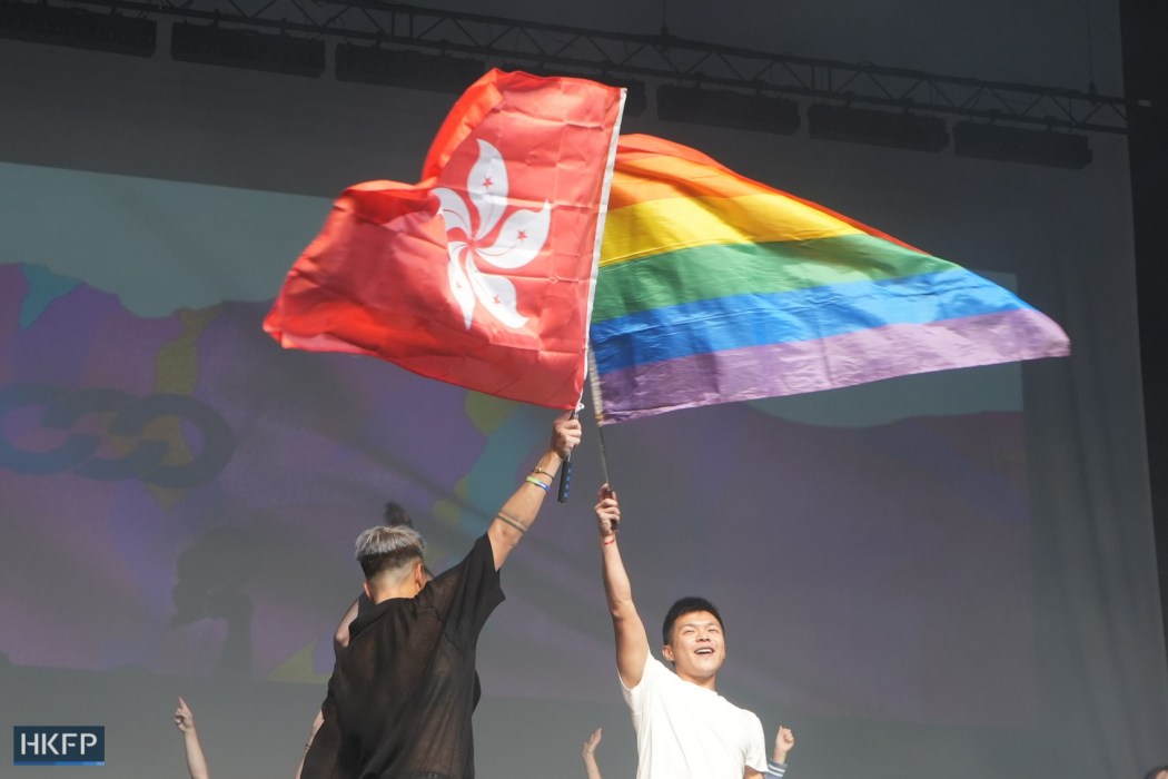 Performers hoist the Hong Kong flag and the rainbow flag on stage during the closing ceremony of Gay Games Hong Kong 2023. Photo: Hans Tse/HKFP.
