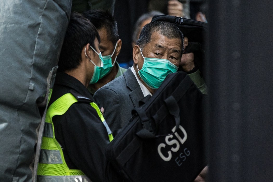 (Files) Pro-democracy media tycoon Jimmy Lai (right) is escorted into a Correctional Services van outside the Court of Final Appeal in Hong Kong on February 1, 2021, after being ordered to remain in jail while judges consider his fresh bail application, the first major legal challenge to a sweeping national security law Beijing imposed on the city last year. Photo: AFP.