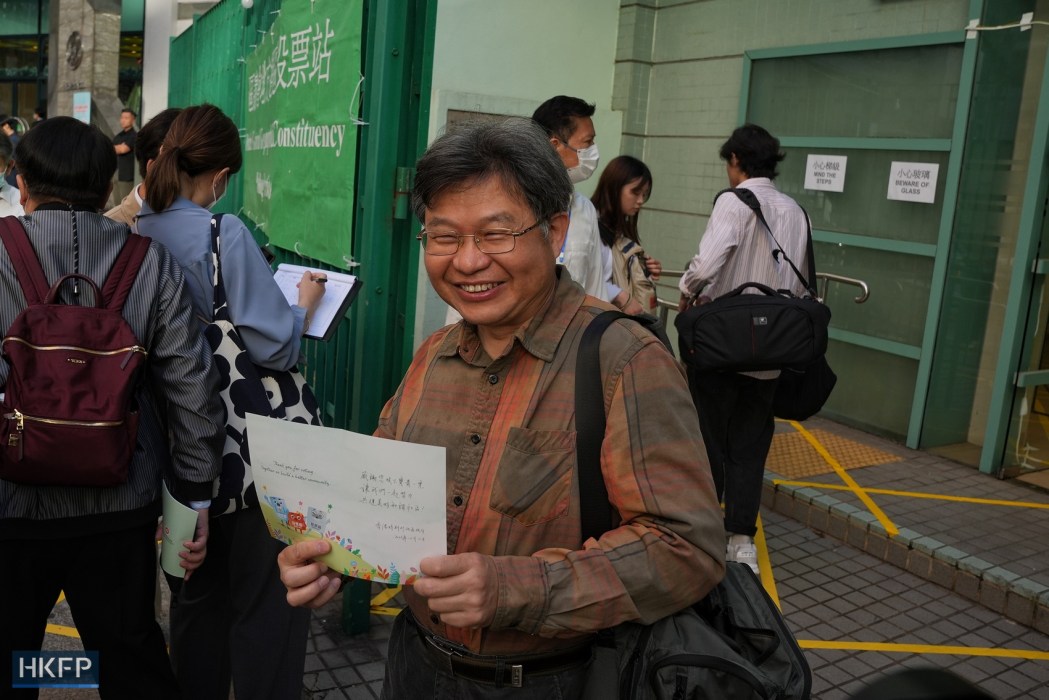 A retired civil servant poses outside a polling station in Mid-Levels after casting his vote in Hong Kong District Council election, on December 10, 2023. Photo: Kyle Lam/HKFP.