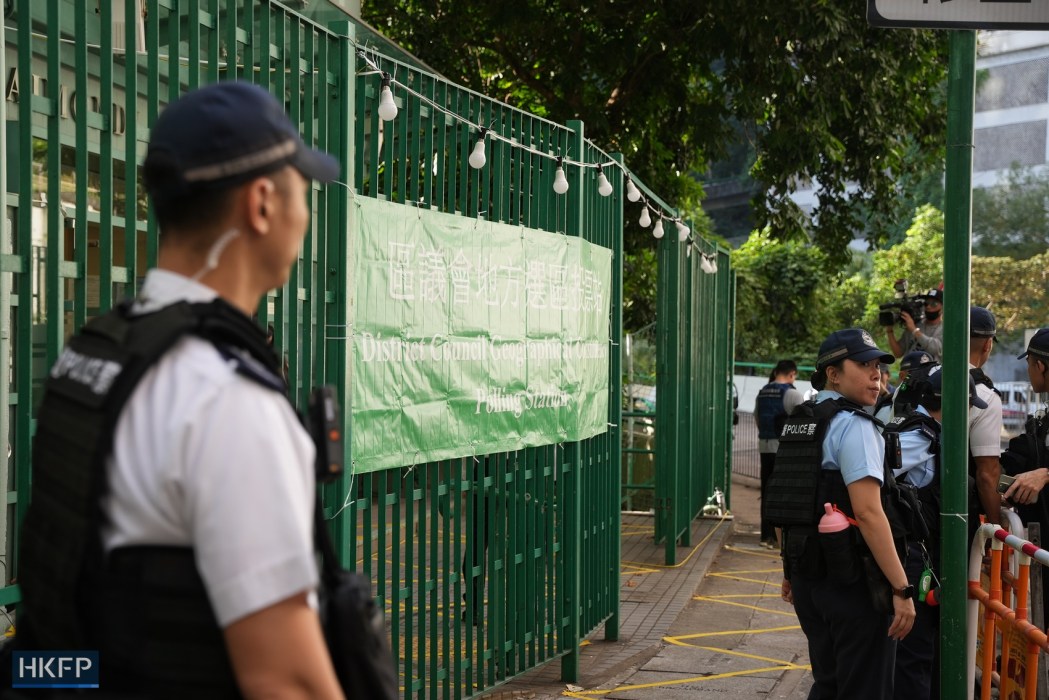 Police outside a polling station in Mid-Levels, on December 10, 2023. Photo: Kyle Lam/HKFP.