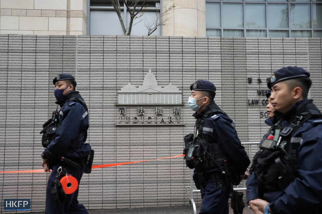 Police officers outside the West Kowloon Law Courts Building on December 18, 2023. Photo: Kyle Lam/HKFP.
