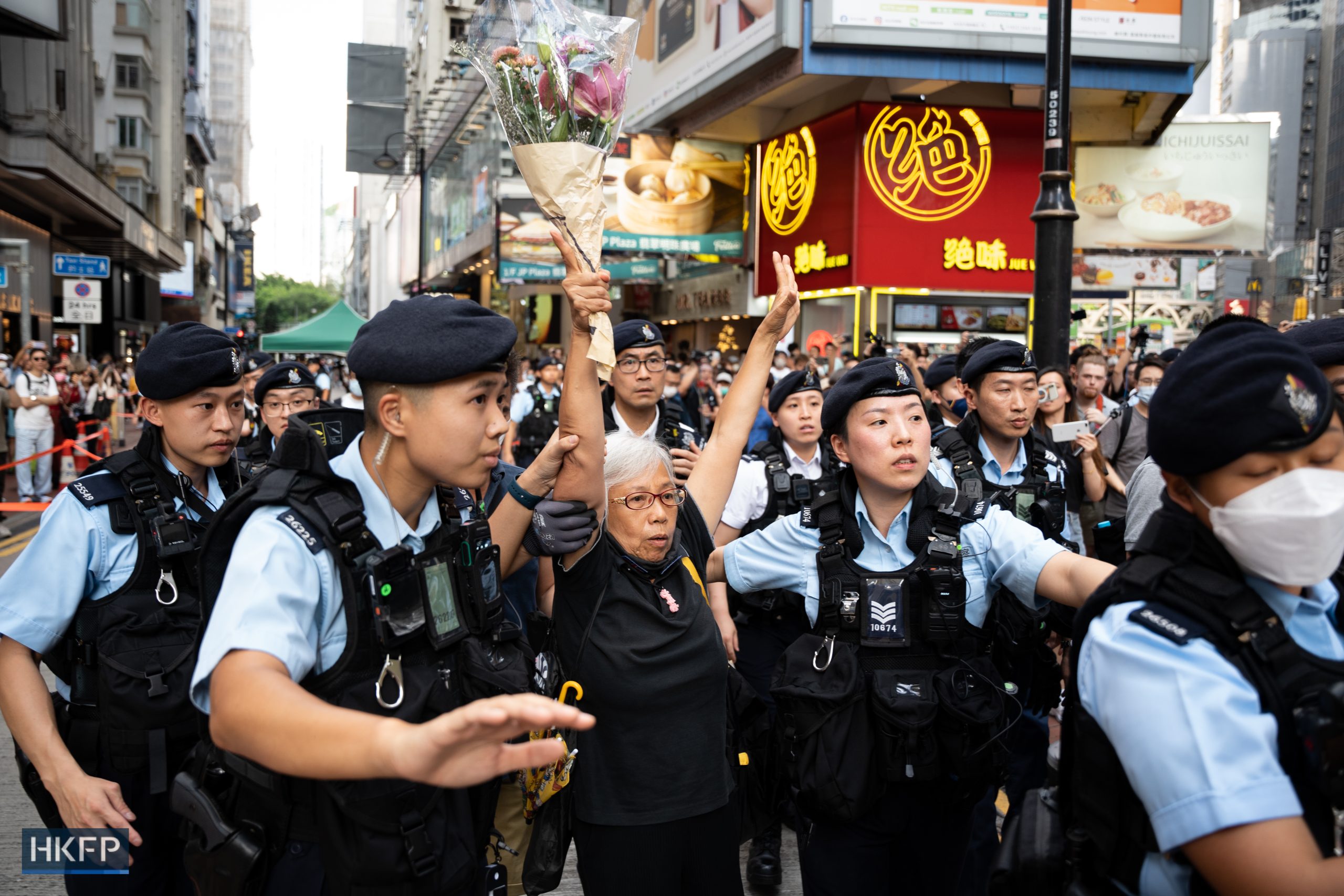 Veteran activist Grandma Wong is taken away by police in Causeway Bay on June 4, 2023, the 34th anniversary of the Tiananmen crackdown. Photo: Kyle Lam/HKFP.
