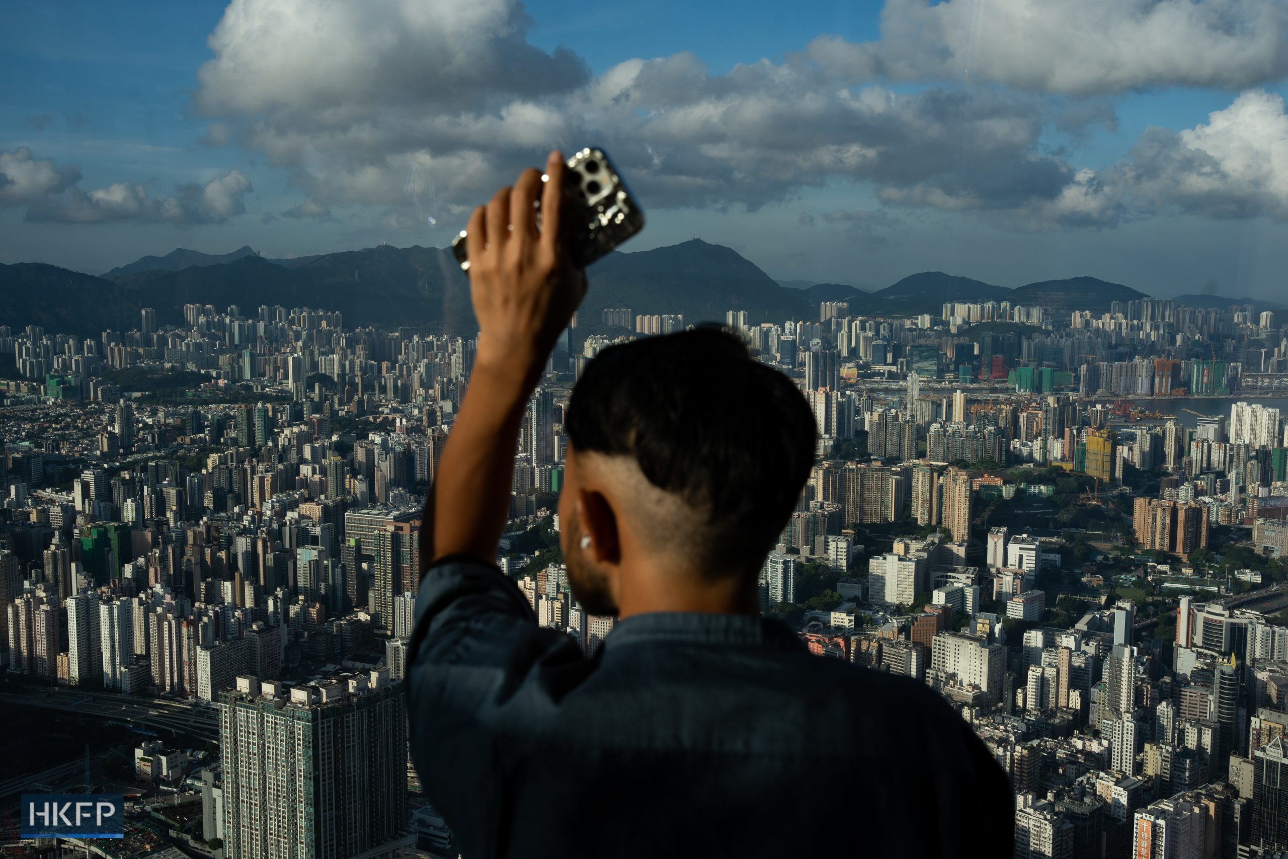 A man looks at the city view of Hong Kong on the observation deck in the International Commerce Centre. File photo: Kyle Lam/HKFP.