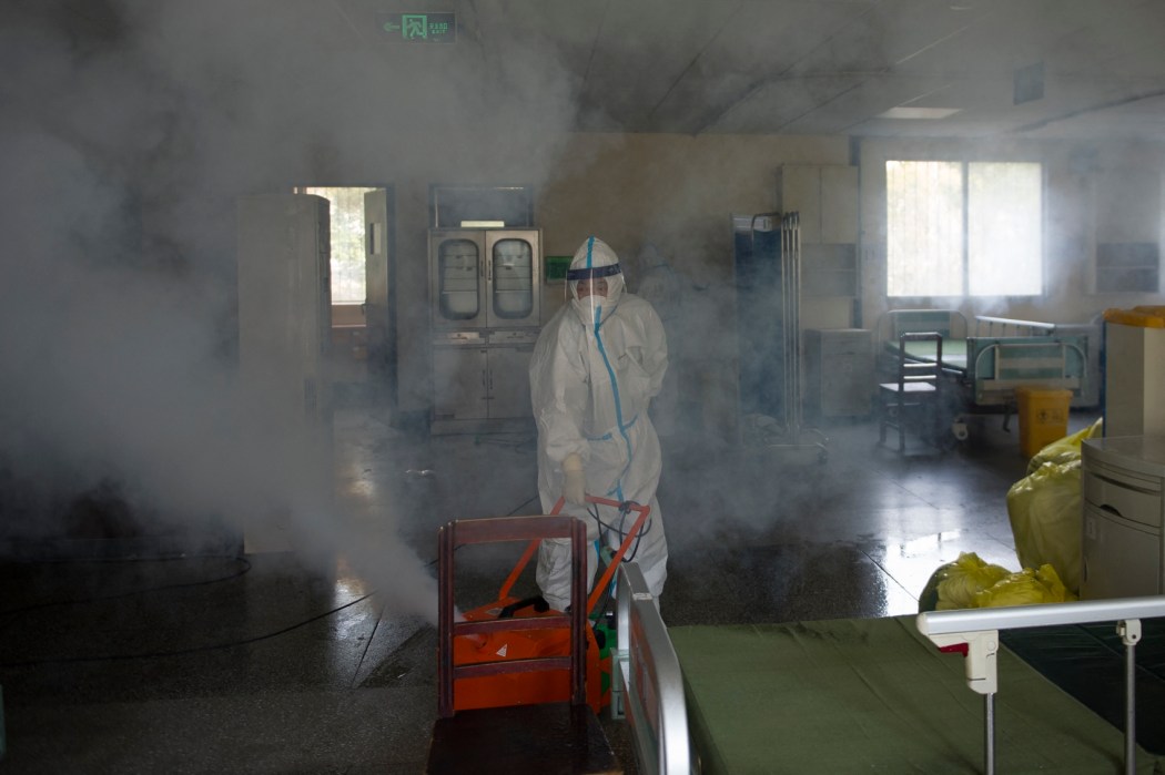 A worker wears a protective suit as he disinfects a room in the Wuhan No.7 hospital in Wuhan, in China's central Hubei province on March 19, 2020. Photo: AFP/China Out. 