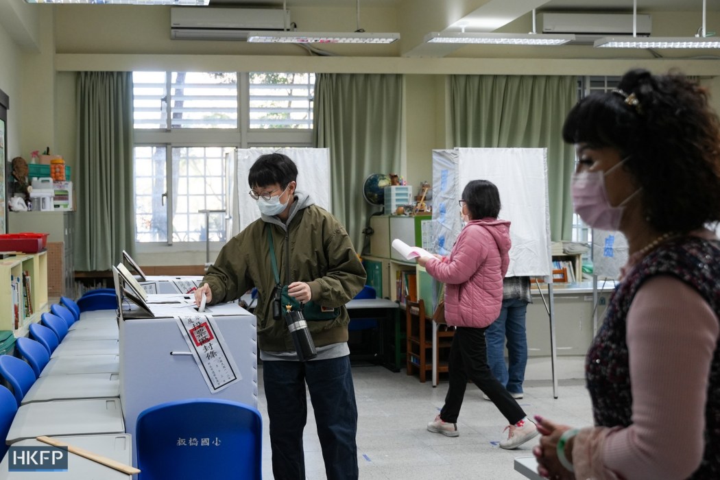 A young man votes in Taiwan's presidential and primary elections at a polling station in Banqiao, New Taipei City, on January 13, 2024. Photo: Kyle Lam/HKFP.