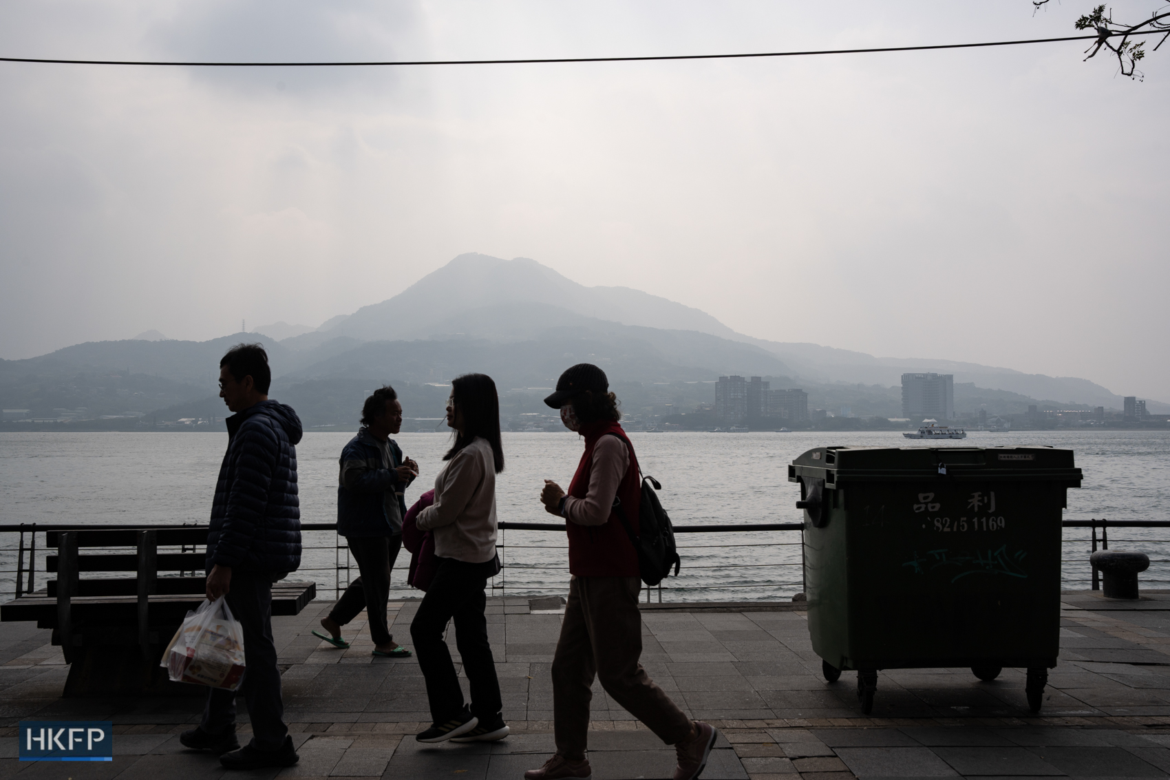 People walk along Tamsui pier, in Taiwan, on January 10, 2024. Photo: Kyle Lam/HKFP.