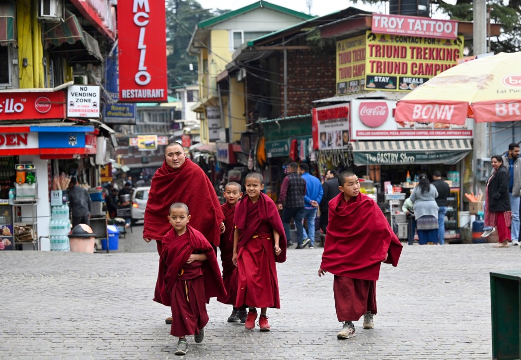 Buddhist monks walk down a street in McLeod Ganj near Dharamsala on February 18, 2024. - Photo: Sajjad Hussain/AFP.