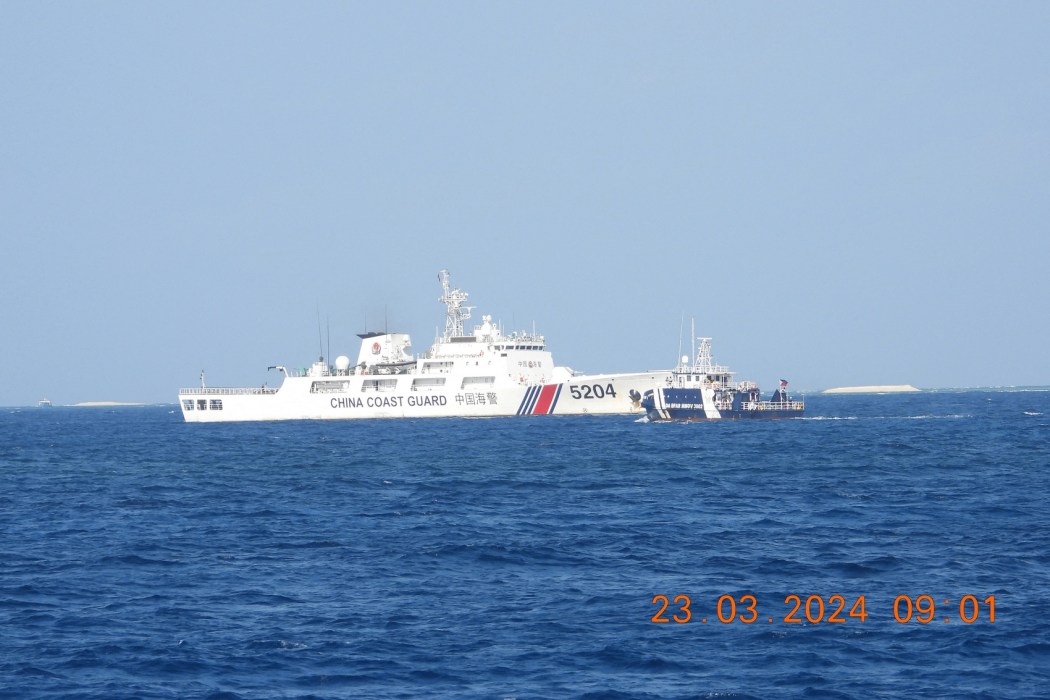 A Chinese Coast Guard ship (left) blocks a Bureau of Fisheries and Aquatic Resources ship on the their way to inspect a cay near the Philippine-held Thitu Island, in the Spratly Islands, in the disputed South China Sea on March 23, 2024.
