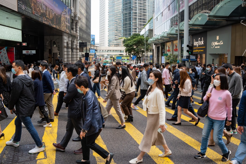 People cross the street in Central, Hong Kong, on February 13, 2023. Photo: Kyle Lam/HKFP.  