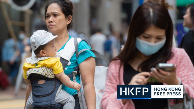 Carers carrying a baby in a street of Hong Kong in October 2023. File photo: Kyle Lam/HKFP.