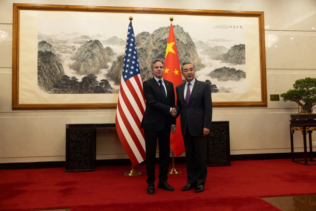 China's foreign minister Wang Yi (right) holds hand with US Secretary of State Antony Blinken on April 26, 2024.