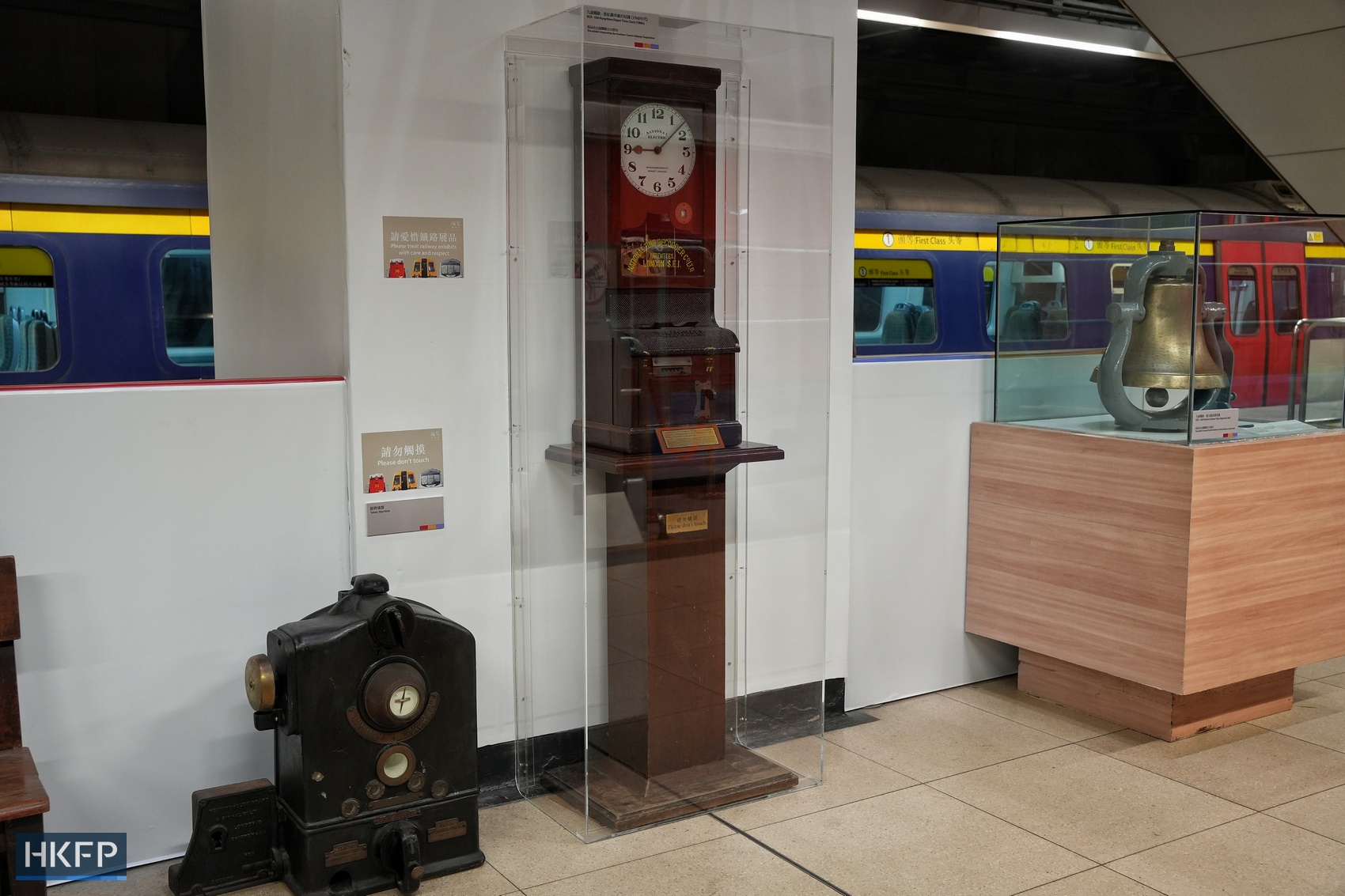 An old Hung Hom depot time clock (centre), an old Kowloon Station train departure bell (right) of the Kowloon-Canton Railway, and a black token machine are showcased at the “Station Rail Voyage” exhibition, presented by the MTR Corporation.
