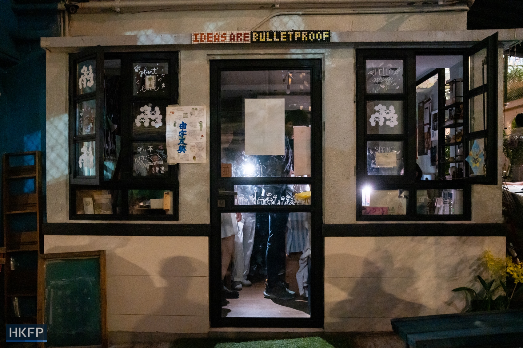 Hong Kong independent bookstore Mount Zero dims its lights as night falls on March 31, 2024, as hundreds gather to pay tribute to the shop. Photo: Kyle Lam/HKFP.