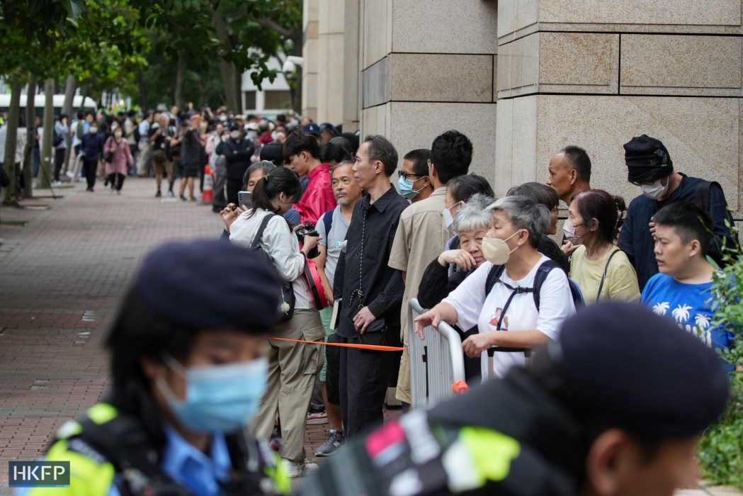 A long line of people waiting to get into the West Kowloon Law Courts Building on May 30, 2024, where three judges will deliver their verdict to 16 defendants involved in the city's largest national security case. Photo: Kyle Lam/HKFP