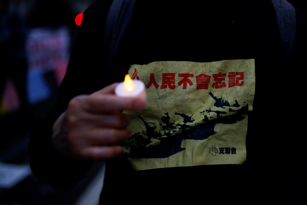 A person holds a candle while taking part in a vigil outside the China's embassy, in London, on June 4, 2024 to mark the 35th anniversary of the 1989 Tiananmen Crackdown. (Photo by Benjamin Cremel/ AFP)