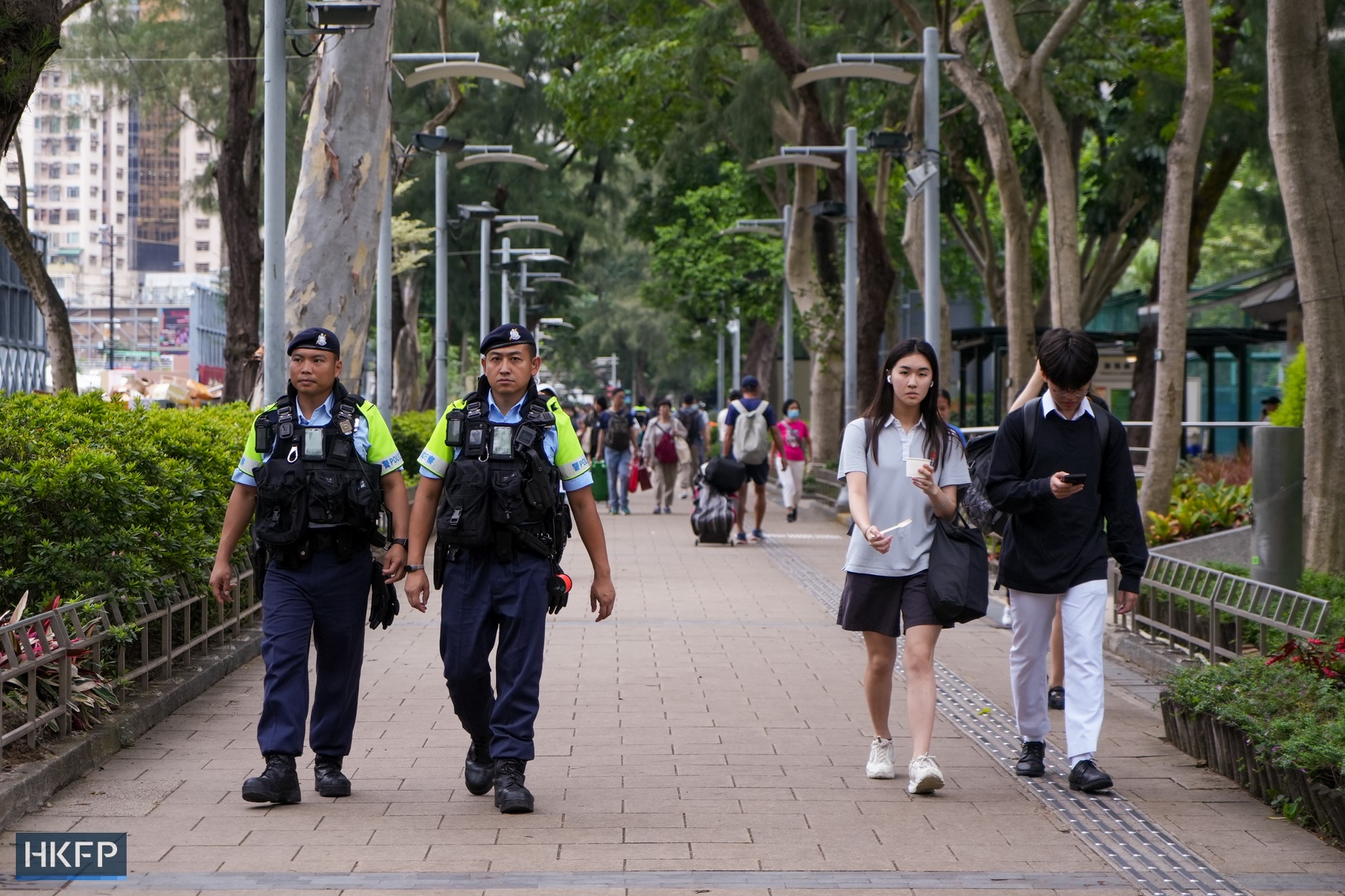 Police patrol Victoria Park in Causeway Bay, Hong Kong, in groups, as a five-day "Hometown Market" is being held by pro-Beijing groups on June 4, 2024. Photo: Kelly Ho/HKFP.
