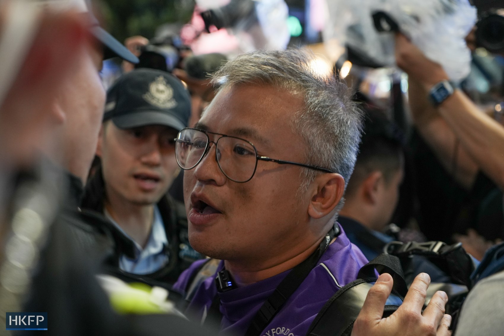 Hong Kong Journalists Association chairman Ronson Chan speaks to a police officer in Causeway Bay on June 4, 2024. Photo: Kelly Ho/HKFP.
