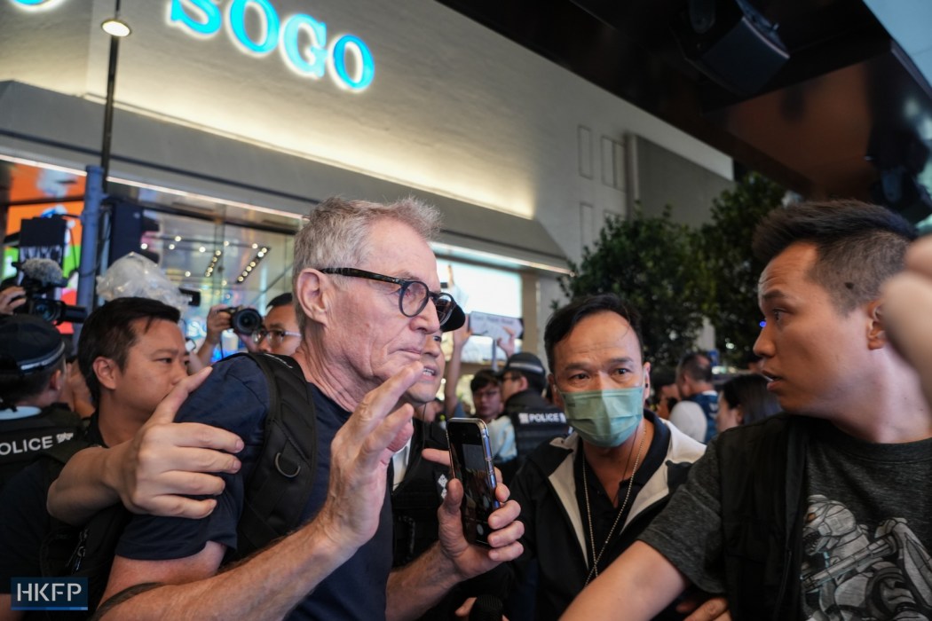 Swiss photographer Marc Progin is led away by police officers in Causeway Bay, Hong Kong, on June 4, 2024, the 35th anniversary of the 1989 Tiananmen crackdown. Photo: Kelly Ho/HKFP.